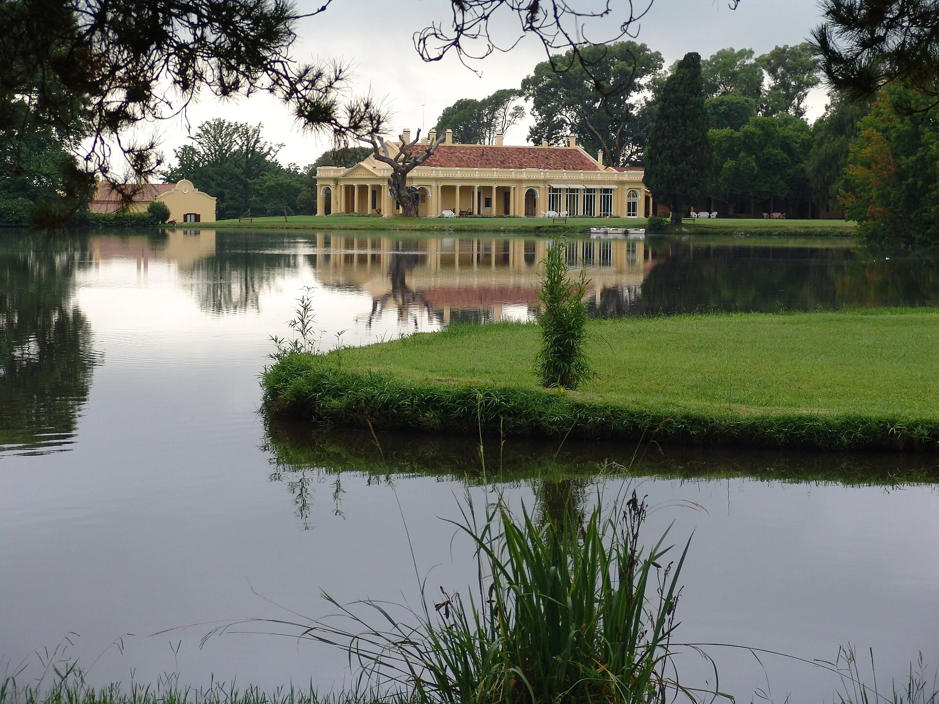 Historic Estancia La Paz reflected in its lake in Córdoba Province